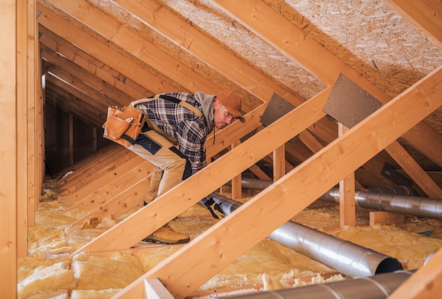 Home Constractor Assembles HVAC Pipe System In Attic