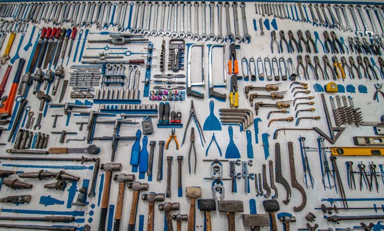 a lot of tools hanging on the wall
