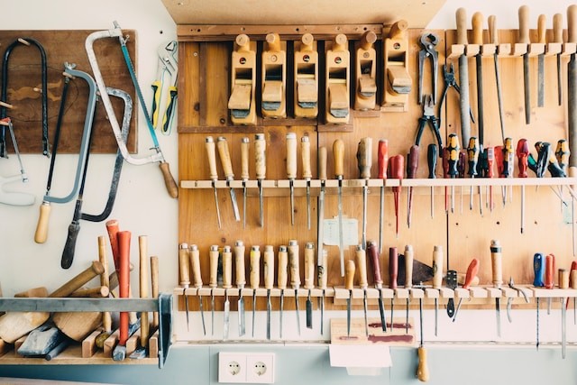 assorted handheld tools in tools rack