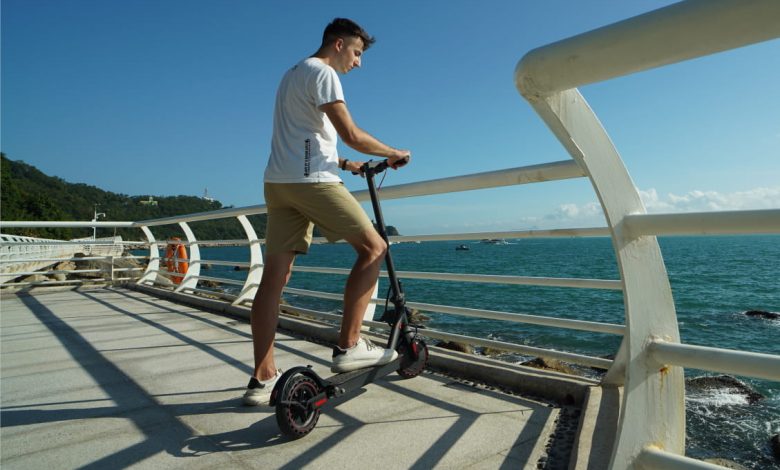 person on scooter near the sea