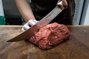 person slicing the meat
