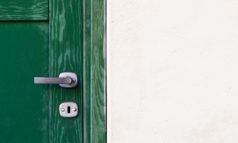 green wooden door with lock