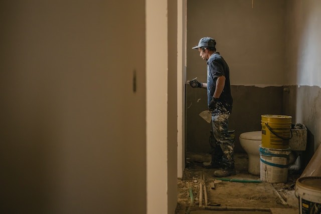 person in process of repairing the bathroom