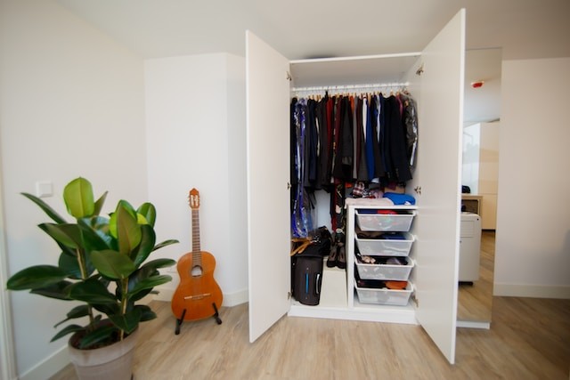 wardrobe with hanging clothes and drawers