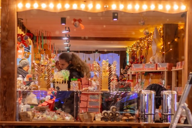 a woman standing in front of a store window