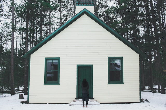 girl in front of house in winter