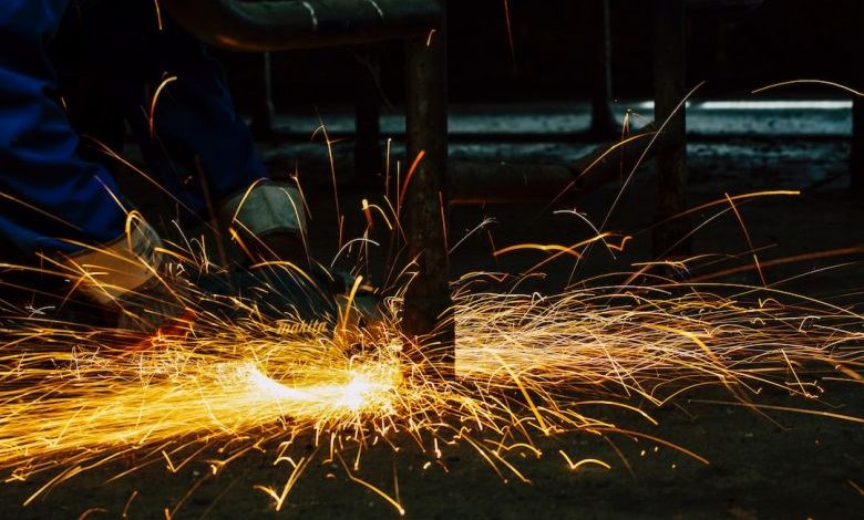 Bench Vice - welders working on a piece of metal with sparks