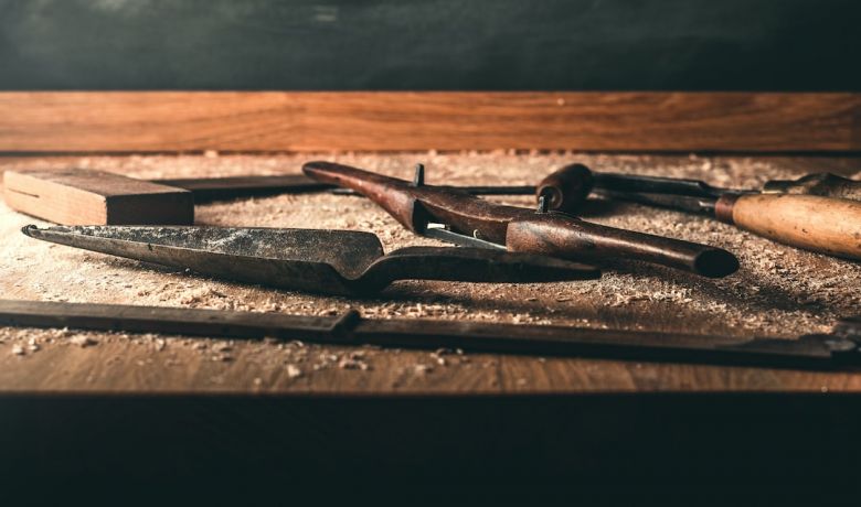 Carpentry Tools - black hammer on brown wood