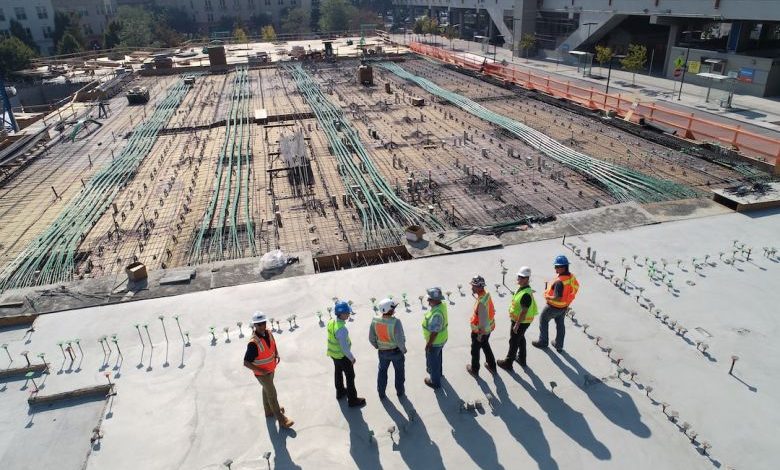 Construction - seven construction workers standing on white field