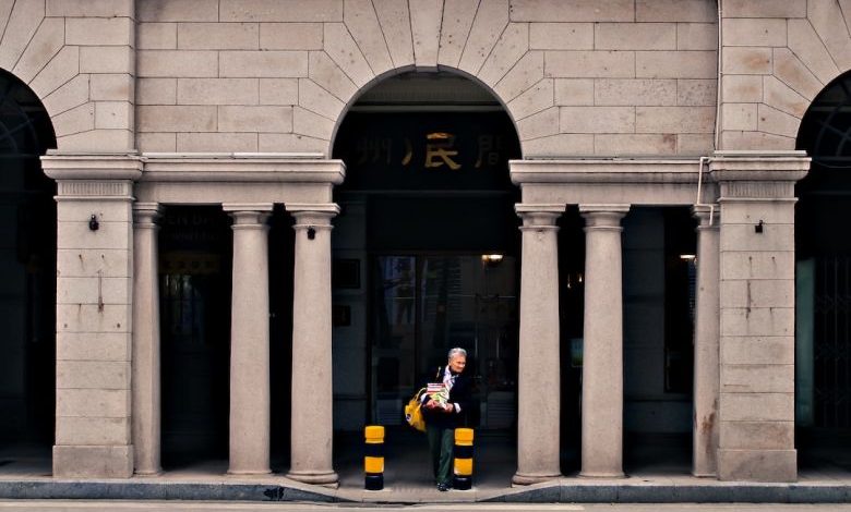 Beautify Entrance - man standing in front of the gray building