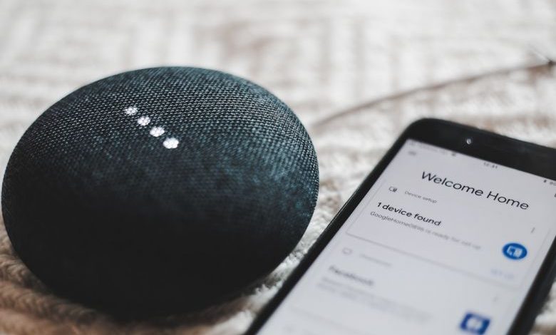 Smart Home - turned-on charcoal Google Home Mini and smartphone