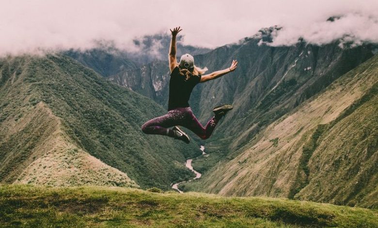 Reduce Noise - woman jumping on green mountains