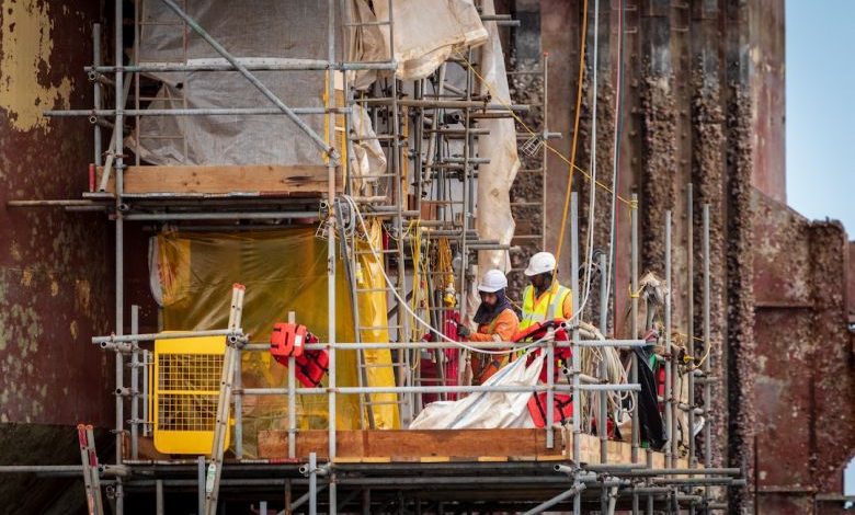 Construction Waste - men on scaffolding