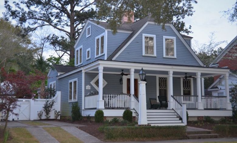 House Siding - white and blue wooden house near green trees during daytime