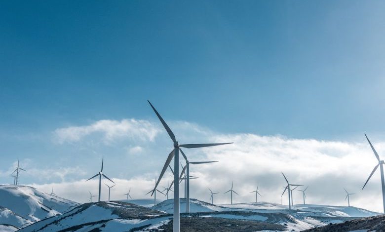 Home Generator - wind turbines on snowy mountain under clear blue sky during daytime