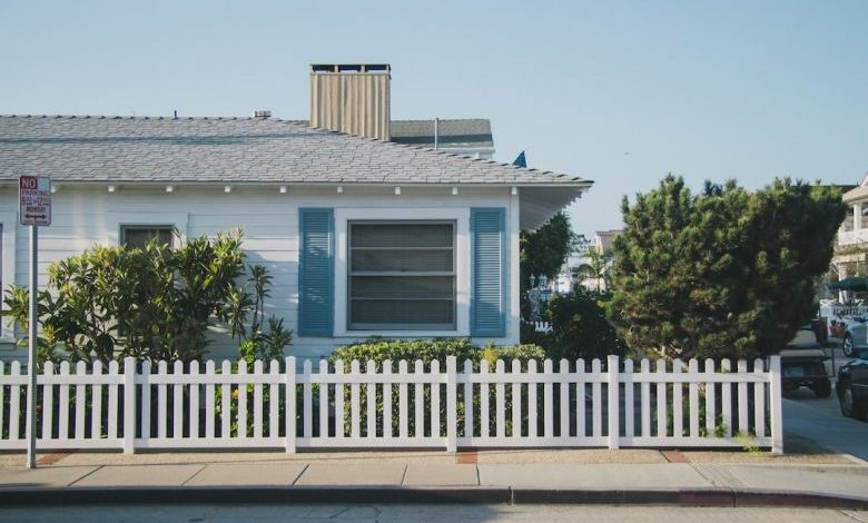 Property Fence. - white and blue house beside fence