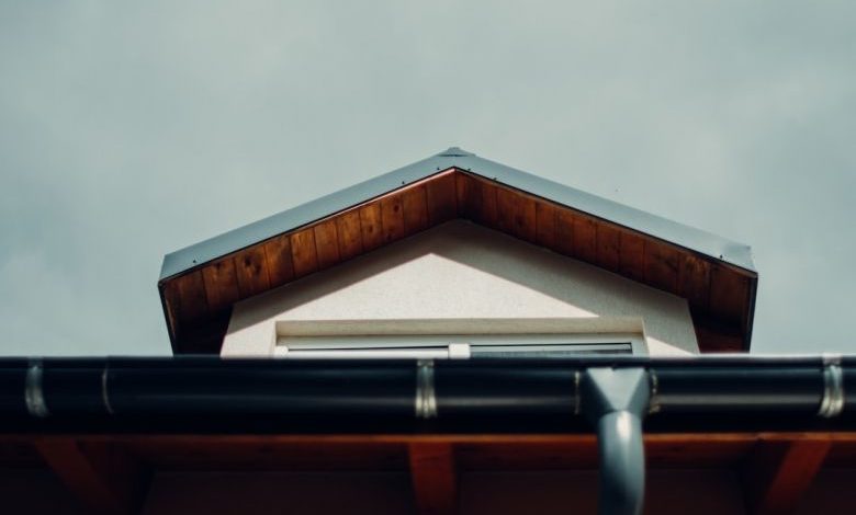 Gutter - brown wooden roof under white sky during daytime