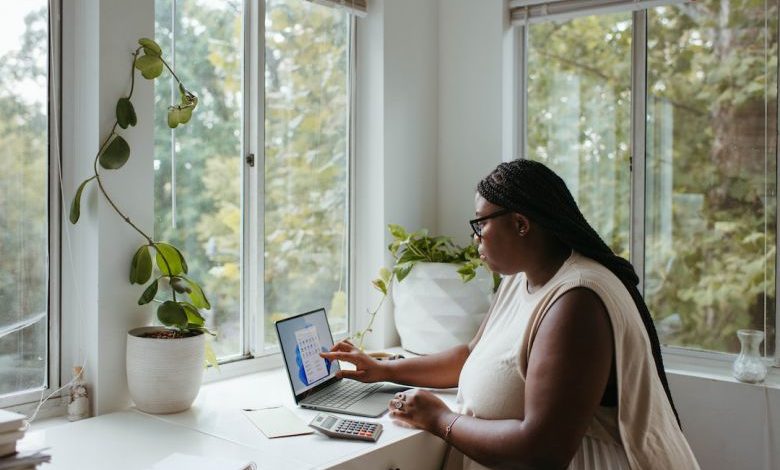 Home Office - a woman sitting at a table with a laptop