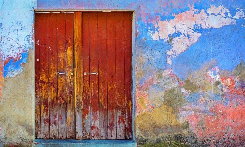 Install Door - red wooden door of blue, red, and brown painted wall