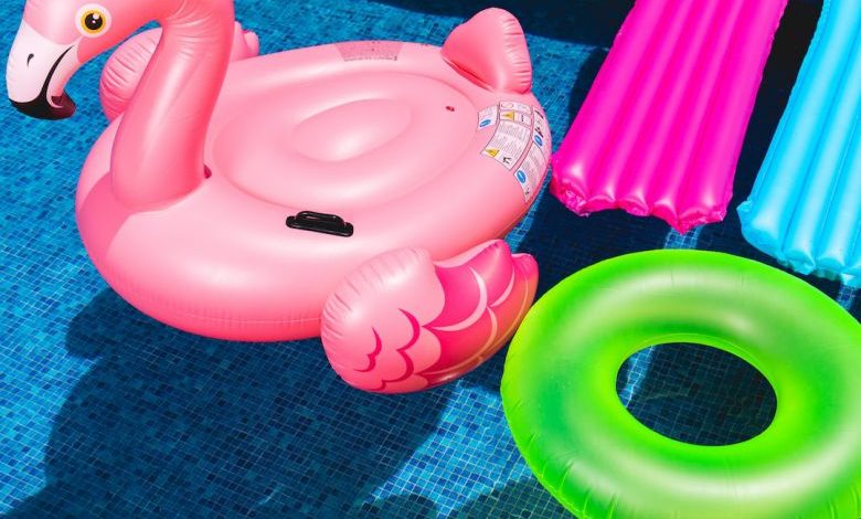 Backyard Swimming Pool - pink inflatable flamingo and green inflatable ring