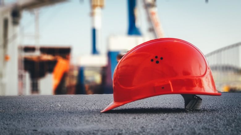 Construction Site - red hard hat on pavement