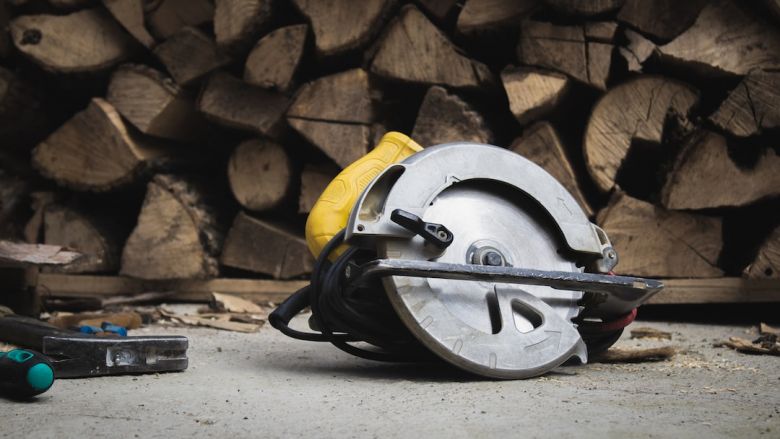 Circular Saw - black and yellow helmet on white concrete floor