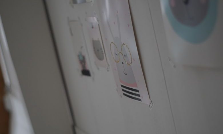 Child's Bedroom - a close up of a refrigerator with magnets on it