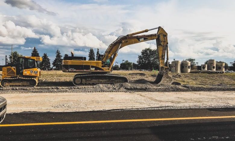 Construction Site - yellow Caterpillar excavator digging up dirt