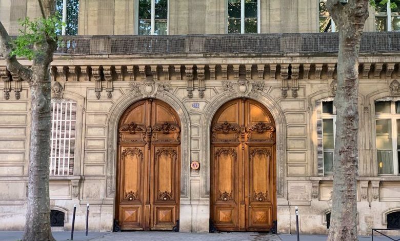Door Design - a couple of large wooden doors in front of a building