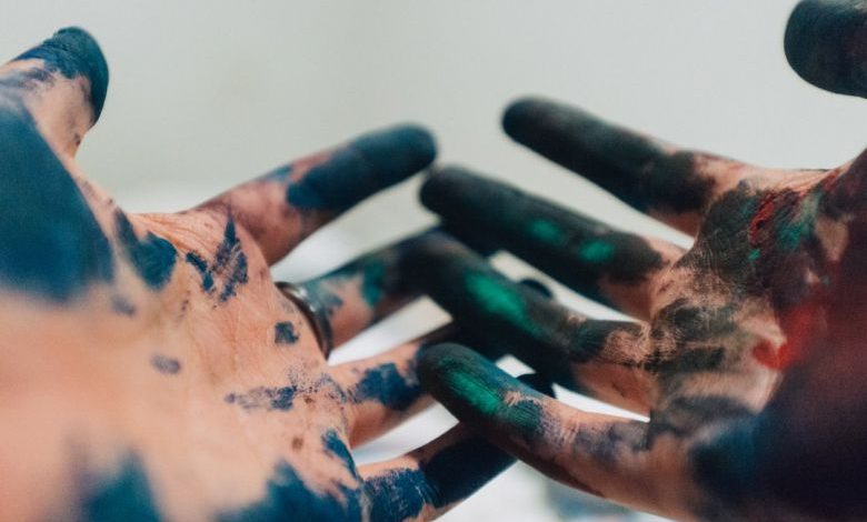 Eco-friendly Paint - person hand with green and blue paint