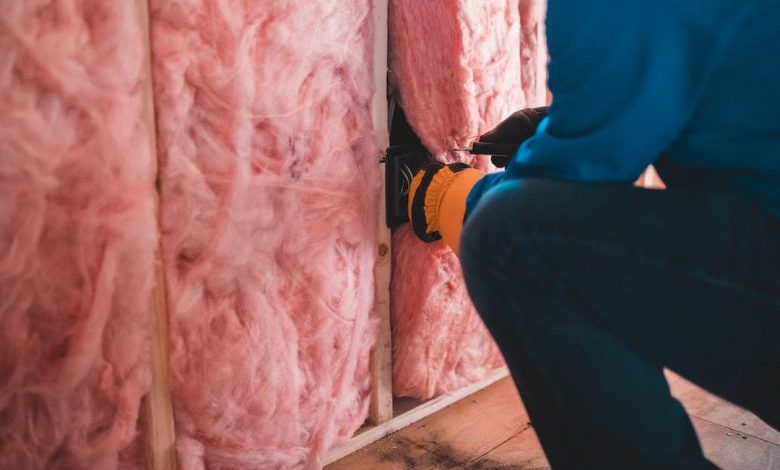 Home Insulation - person in blue pants sitting on brown wooden floor