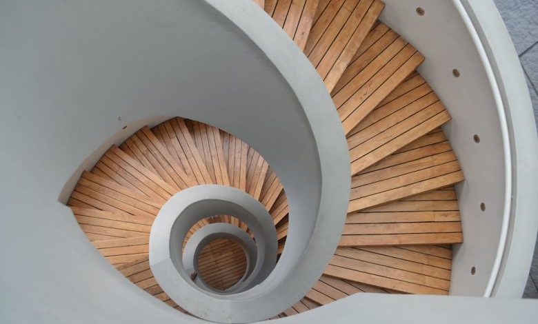 Staircase - brown wooden spiral staircase with white wall
