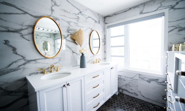 Bathroom Ventilation - a bathroom with two sinks and a large mirror