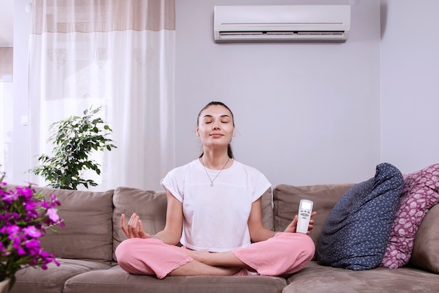 person making yoga in room with ac