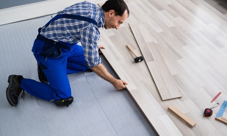 worker-installing-home-floor-carpenter-laying-laminate-flooring