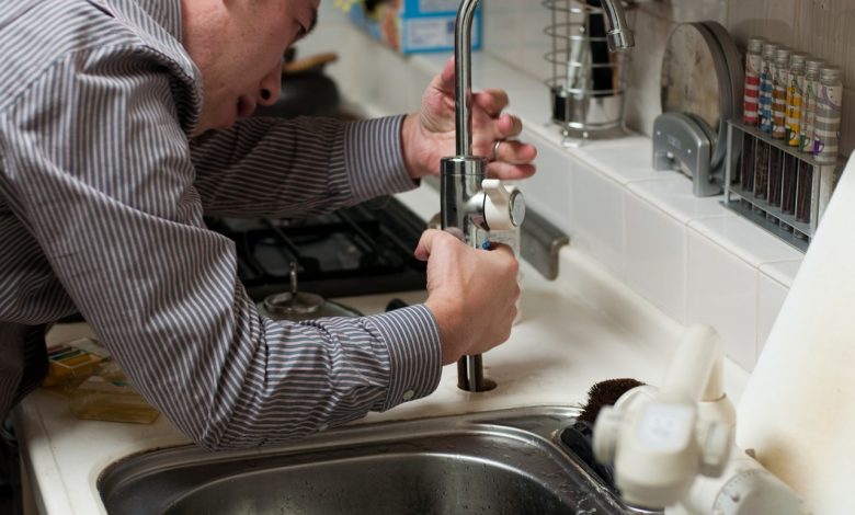 plumber repairing the faucet