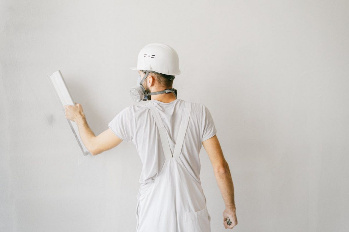 a-construction-worker-working-on-the-wall-of-a-house