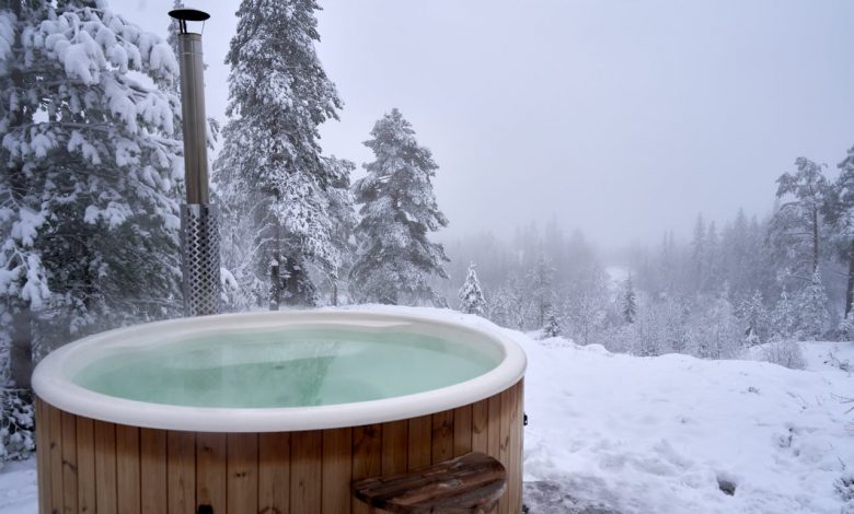 a-brown-wooden-jacuzzi-on-snow-covered-ground-during-winter