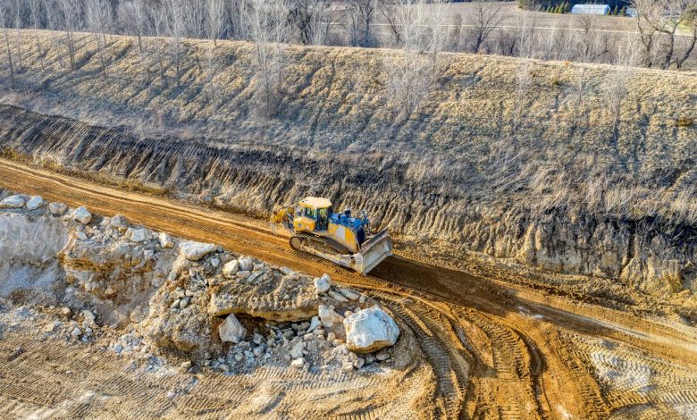 a-grader-paving-the-dirt-road