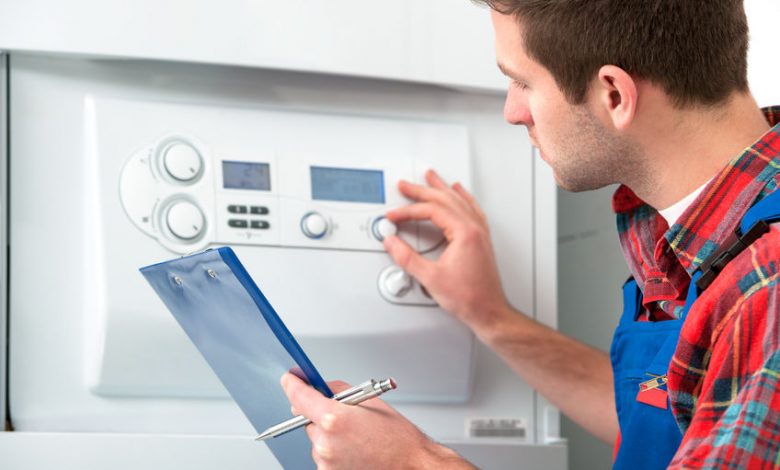 Technician servicing heating boiler