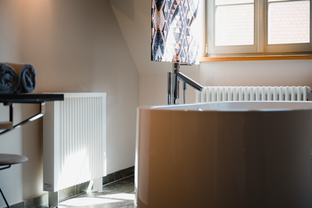 a-room-with-a-white-heater-and-a-window