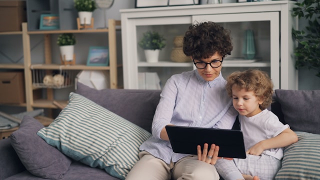 a-woman-sitting-on-a-couch-with-a-child-on-her-lap